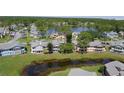 Overhead view of the community showcasing the surrounding pond and mature tree coverage at 105 Wood Duck Cir # D, Daytona Beach, FL 32119