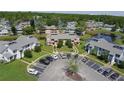 Aerial view of the townhome complex, showcasing well-maintained landscaping and nearby pond views at 105 Wood Duck Cir # D, Daytona Beach, FL 32119