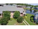 Charming townhouse near a lake featuring manicured landscaping and a walkway to the entrance at 105 Wood Duck Cir # D, Daytona Beach, FL 32119