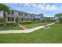 A sidewalk bench facing a row of townhomes with beautiful lawns and shrubbery at 11812 Metaphor Aly, Orlando, FL 32832