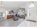 Bright foyer with tile flooring, arched window, and an open living area at 1199 Stoneham Dr, Groveland, FL 34736