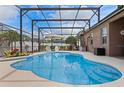 Relaxing screened-in pool area perfect for entertaining, featuring a hot tub and ample seating at 12207 Shadowbrook Ln, Orlando, FL 32828