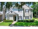 Inviting two-story townhome with lush lawn and mature trees providing shade at 1300 Eastern Pecan Pl # 104, Winter Garden, FL 34787