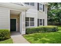 Charming townhome exterior with dark green door and tidy landscaping at 1300 Eastern Pecan Pl # 104, Winter Garden, FL 34787