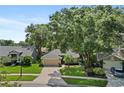 An aerial view of a well-maintained, single-story home with a lush lawn, landscaped yard, and a two-car garage at 1354 Dutch Elm Dr, Altamonte Springs, FL 32714