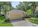 Attractive one-story home with a two-car garage, manicured lawn, and inviting curb appeal at 1354 Dutch Elm Dr, Altamonte Springs, FL 32714