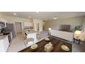 Spacious open floor plan with kitchen island, dining table and cozy living area at 1397 Dalkeith Cv, Sanford, FL 32771