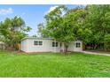 Single story home with a freshly mowed front lawn, recently painted exterior, and mature trees at 147 Country Club Dr, Sanford, FL 32771
