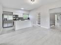 Modern kitchen with stainless steel appliances, white cabinets, and a sleek kitchen island at 147 Country Club Dr, Sanford, FL 32771