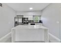 Open kitchen featuring stainless steel appliances, stylish backsplash, and a functional island at 147 Country Club Dr, Sanford, FL 32771