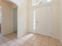 Welcoming home foyer with tiled floors and a window above the front door for natural light at 15309 Markham Dr, Clermont, FL 34714