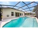 Relaxing screened-in pool area with a turquoise pool, a built-in spa and lounge chairs for enjoying the sunny weather at 15309 Markham Dr, Clermont, FL 34714