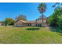 Charming single-story home with a well-manicured lawn and mature landscaping, creating excellent curb appeal at 1842 Evergreen Dr, Edgewater, FL 32141