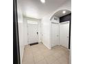 Welcoming foyer features a neutral tile floor, a black accent wall and a view of the front door at 238 Miniehaha Cir, Haines City, FL 33844