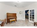 Home office with a piano, neutral walls, and tile flooring at 2401 Oxmoor Dr, Deland, FL 32724
