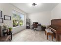 Bright home office featuring a large window, neutral walls, and tile flooring at 2401 Oxmoor Dr, Deland, FL 32724