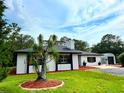 Beautiful single-story home showcasing its manicured lawn, landscaping and a metal storage shed at 2630 S Tanner Rd, Orlando, FL 32820