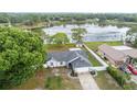 Picturesque aerial view of the home with serene lake views, lush greenery, and fenced in yard at 2916 Maldive Ct, Deltona, FL 32738