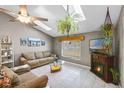 Comfortable living room with vaulted ceiling, fireplace, and tile flooring at 2916 Maldive Ct, Deltona, FL 32738