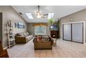 Cozy living room with skylights, fireplace, and neutral tones at 2916 Maldive Ct, Deltona, FL 32738
