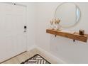 Stylish entryway boasts a floating shelf with decor, a round mirror, and a modern rug at 2923 Banana Palm Dr, Kissimmee, FL 34747