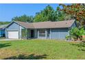 Charming single-story home boasting lush green lawn and inviting curb appeal perfect for a cozy Gathering-friendly atmosphere at 3150 Rider Pl, Orlando, FL 32817