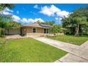 Cozy single-story home featuring solar panels and a spacious driveway at 3431 Hunt Ln, Oviedo, FL 32765