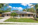 Charming single-story home featuring solar panels and a neatly manicured front lawn at 3431 Hunt Ln, Oviedo, FL 32765