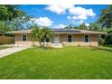 Inviting single-story home with solar panels and a well-maintained lawn at 3431 Hunt Ln, Oviedo, FL 32765