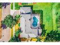 Aerial view of a home showcasing a large swimming pool, patio area, and well-maintained roof at 357 Fairway Pointe Cir, Orlando, FL 32828