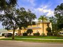Two-story home with manicured lawn, beautiful landscaping, and a side-entry garage at 357 Fairway Pointe Cir, Orlando, FL 32828