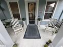 Inviting front porch with chairs, a rug, and decor creating a cozy and welcoming entryway at 3963 Turow Ln, Orlando, FL 32828