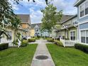 Beautiful shot of the community featuring sidewalks, green spaces and colorful townhomes at 4010 Santa Maria Dr # 106, Kissimmee, FL 34741