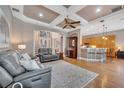 Open-concept living space featuring hardwood floors, a coffered ceiling, and seamless flow into the kitchen at 424 Curry Ct, Altamonte Springs, FL 32714