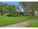 Beautiful home showcasing a well-maintained lawn with mature landscaping, creating a serene and inviting outdoor space at 432 Valley View Dr, Winter Garden, FL 34787
