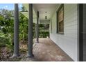 Covered porch with brick flooring, showcasing classic columns and a view of the home's well-maintained landscaping at 432 Valley View Dr, Winter Garden, FL 34787