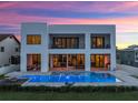 Modern home featuring an outdoor pool with barstools, balconies, and a covered outdoor lounge at 4647 Van Kleeck Dr, New Smyrna Beach, FL 32169