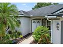 Inviting front entrance with double doors, lush landscaping, and a well-manicured lawn creating a welcoming approach at 468 Alinole Loop, Lake Mary, FL 32746