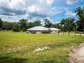 Spacious home on a large lot, featuring a well-maintained lawn and mature trees at 485 Nw 71St Ave, Ocala, FL 34482