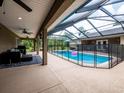 Enclosed pool area with ample seating and a covered patio, perfect for outdoor relaxation and entertainment at 485 Nw 71St Ave, Ocala, FL 34482