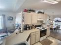 Functional kitchen with plenty of counter space, neutral cabinetry, and adjacent breakfast nook at 517 Westwind Dr, Davenport, FL 33896