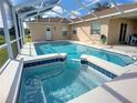 Inviting screened-in pool and spa area, perfect for relaxation and entertainment at 517 Westwind Dr, Davenport, FL 33896