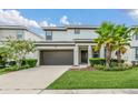 Two-story home with a two-car garage, tidy landscaping, and well-maintained lawn at 518 Marcello Blvd, Kissimmee, FL 34746