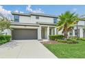 Two-story home with a two-car garage, tidy landscaping, and well-maintained lawn at 518 Marcello Blvd, Kissimmee, FL 34746
