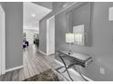 Welcoming hallway with sleek console table and decorative mirror, leading to the living areas at 518 Marcello Blvd, Kissimmee, FL 34746