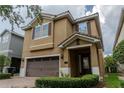 Inviting two-story home featuring a brick driveway, two-car garage, and a meticulously maintained lawn at 531 Lasso Dr, Kissimmee, FL 34747