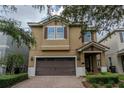 Inviting two-story home featuring a brick driveway, two-car garage, and a meticulously maintained lawn at 531 Lasso Dr, Kissimmee, FL 34747