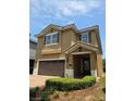 Charming two-story home with a tile roof, an attached two-car garage, and a manicured front yard at 531 Lasso Dr, Kissimmee, FL 34747