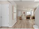 Bright living room with wood-look flooring, modern furnishings, and a welcoming open layout at 7262 Summer Ivy Aly, Orlando, FL 32829