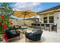 Outdoor kitchen and living space, featuring a built in grill, bar seating, and ample seating at 7974 Chilton Dr, Orlando, FL 32836